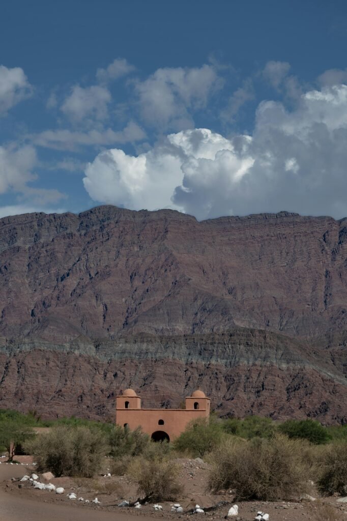 pexels-photo-21050227-21050227 Scenic view of an adobe church set against the majestic mountain range in Catamarca, Argentina.