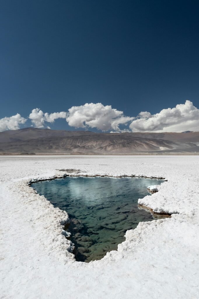 pexels-photo-21274611-21274611 A serene view of Antofalla salt flat with clear skies in Catamarca, Argentina.
