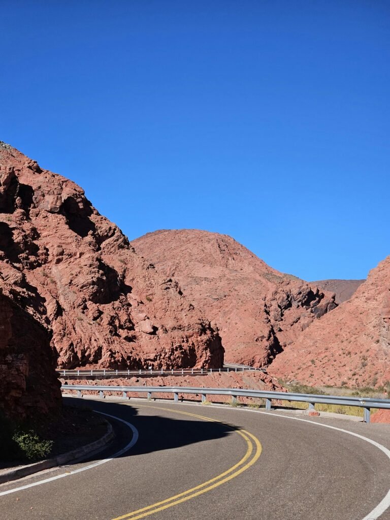 pexels-photo-21558539-21558539 Curving road cutting through the red rock formations of Fiambalá, Catamarca, Argentina.